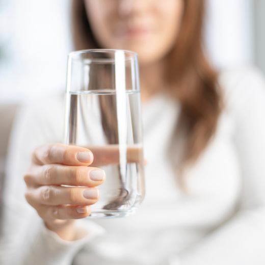 Woman Holding a Glass of Water in Hand