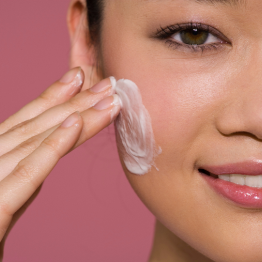 Woman applying moisturizer to sensitive skin