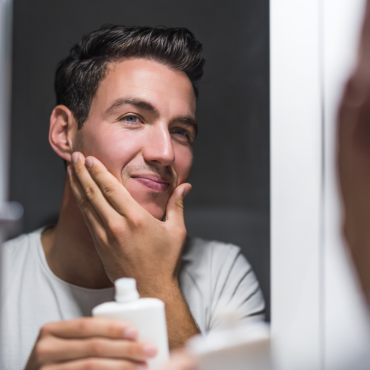 Man Applying Aftershave For Post Shave Skin Care